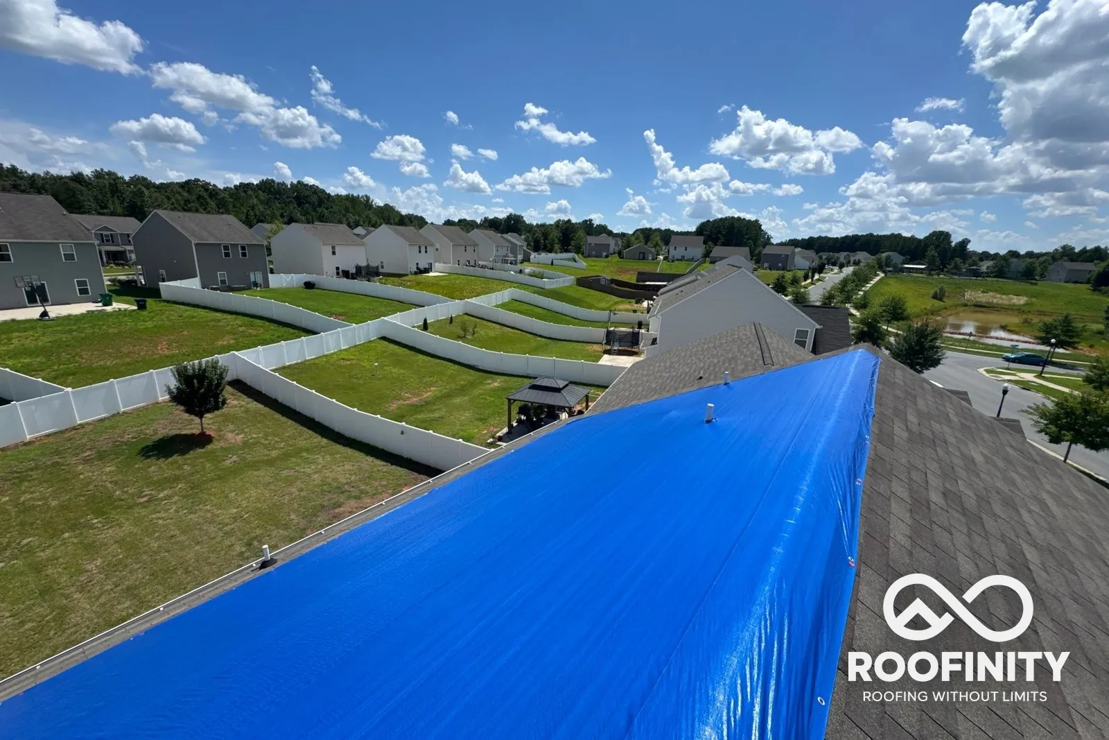Roofinity crew emergency roof tarp on a two-story home