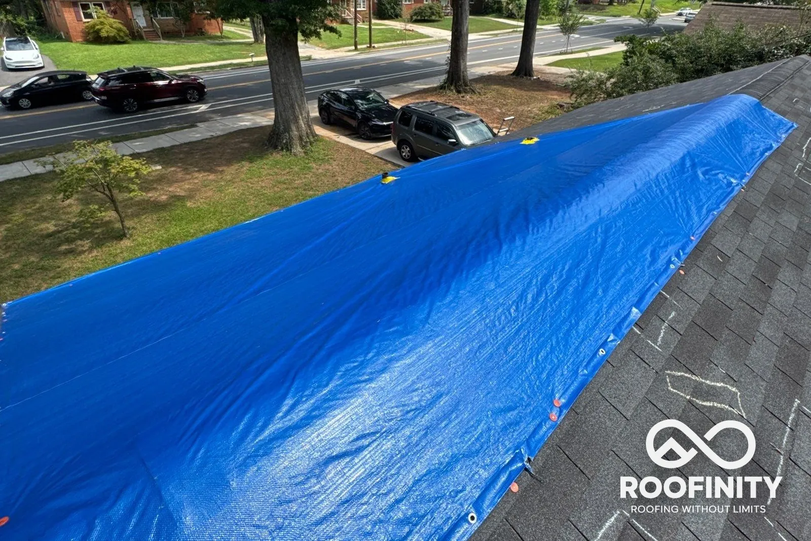 Roofinity temporary roof tarp over storm-damaged shingles