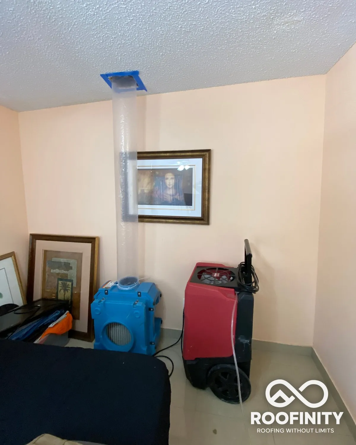 Roofinity dehumidifier and air scrubber drying a ceiling after a roof leak
