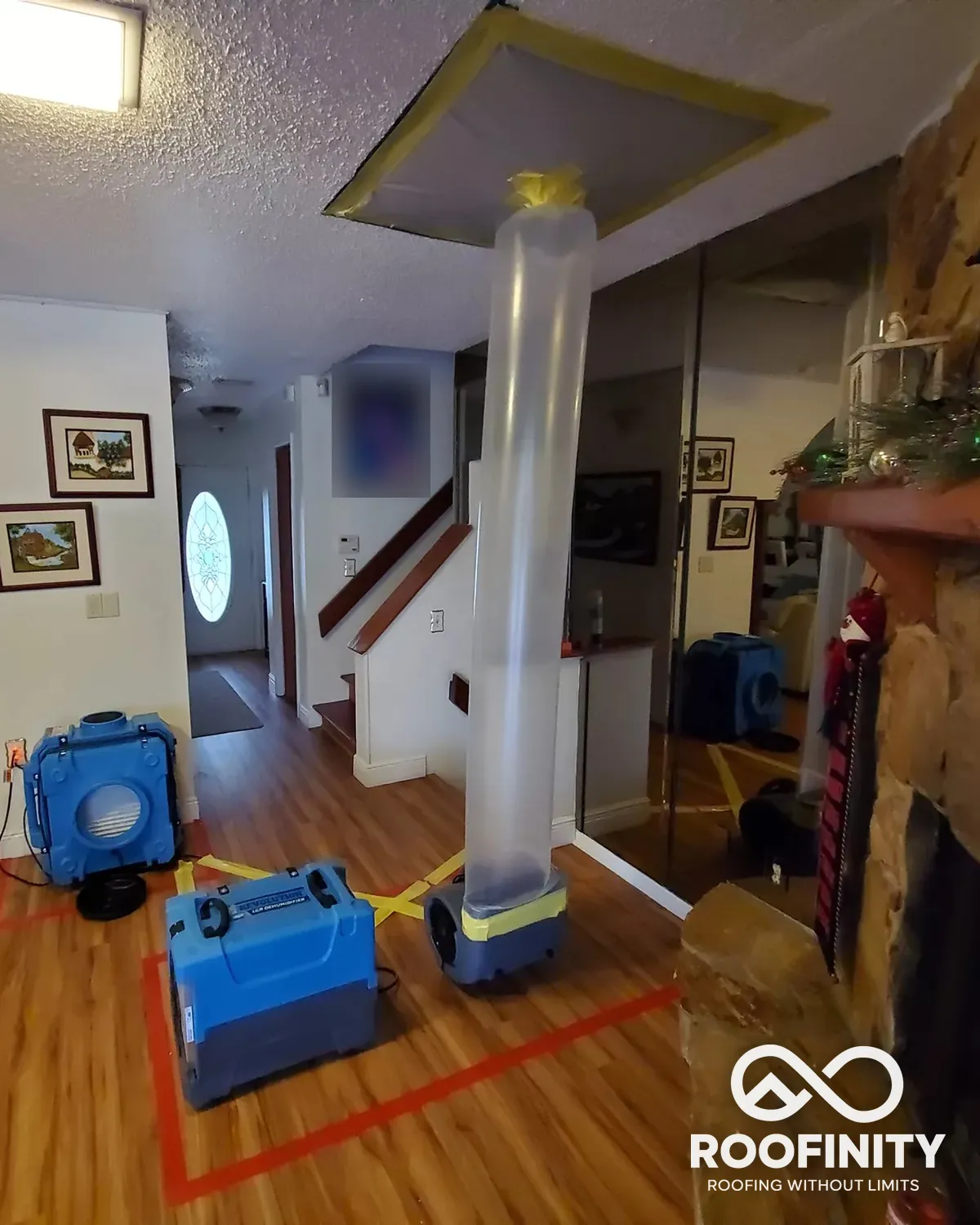 Roofinity drying equipment and containment in a living room after water damage